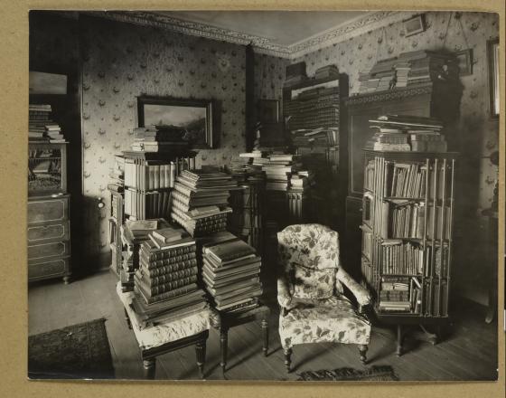 Black and white photo of a room filled with books